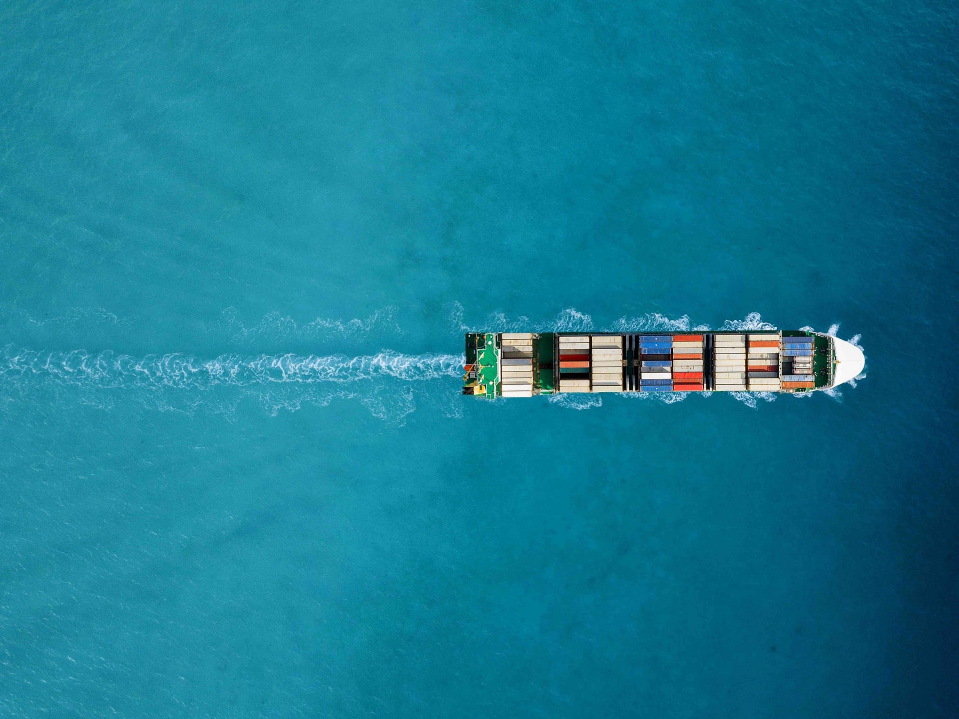 Container ship in export and import. International shipping cargo. Aerial view